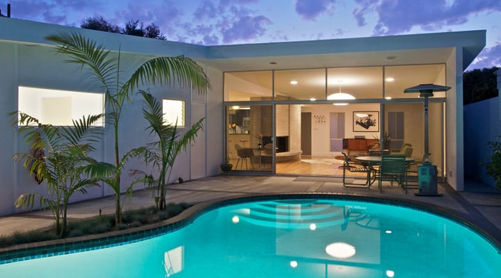 A pool next to a palm tree