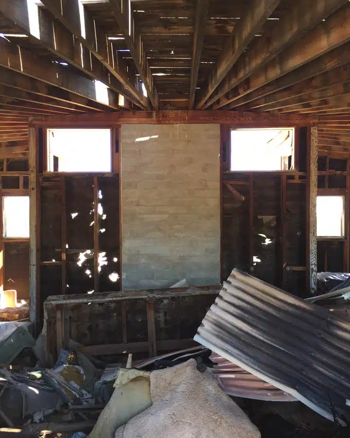 Inside_Middle-720x900 A wooden bench sitting next to a fireplace