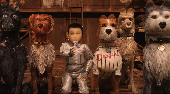 Isle-of-Dogs_720x400 A group of men standing next to a dog