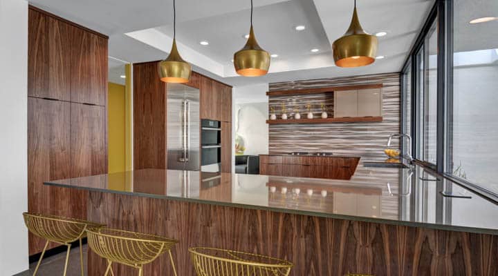 A kitchen with wooden cabinets and a dining table