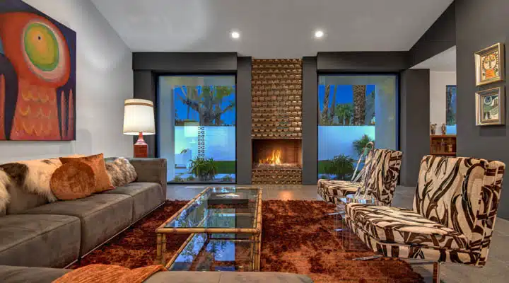 LIVING_ROOM_DETAIL_NIGHT-720x400 A living room filled with furniture and a fire place