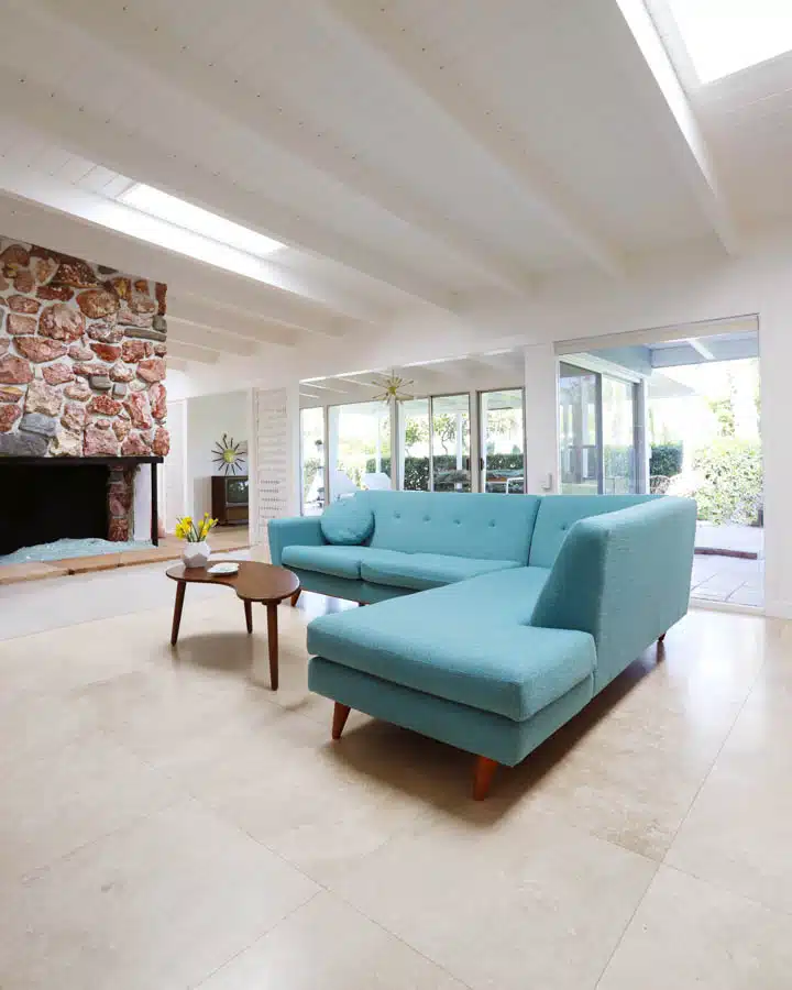 Living_Room_After-720x900 A living room filled with furniture and a large window