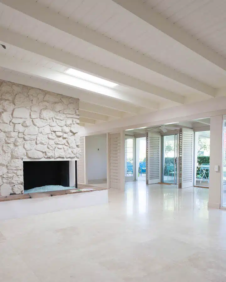 Living_Room_Before-720x900 A room filled with furniture and a fireplace