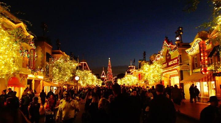 A group of people in front of a large crowd at night