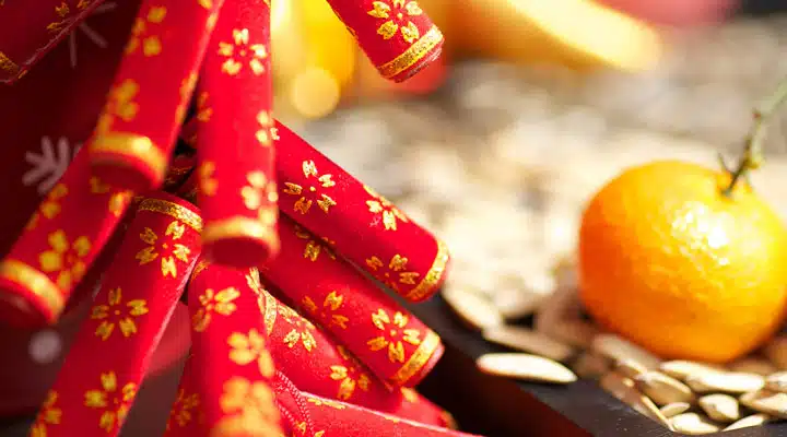Malaysia_CNY_1920_800 Two oranges sitting on top of a table