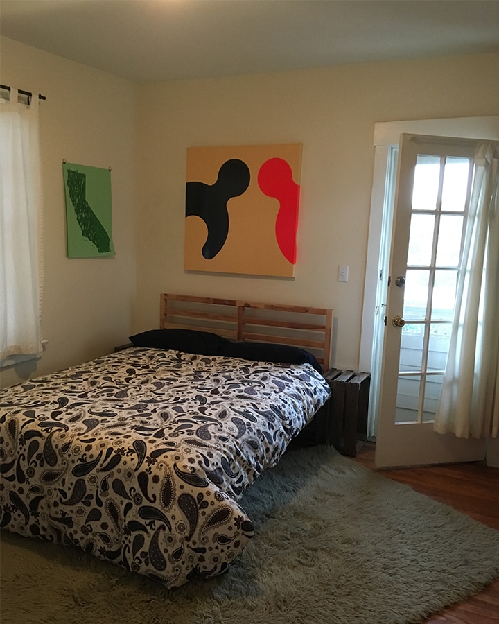 A bedroom with a bed in a room