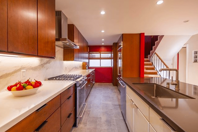 A modern kitchen with stainless steel appliances and wooden cabinets