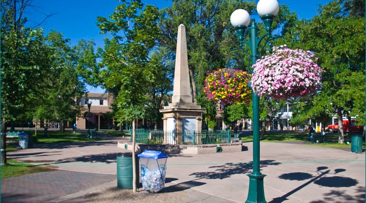 A small clock tower in the middle of the street