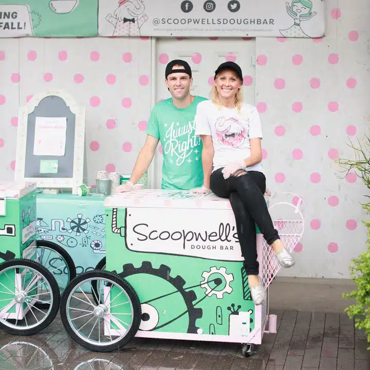 Scoopwells_Owners-720x720 A person holding a sign posing for the camera