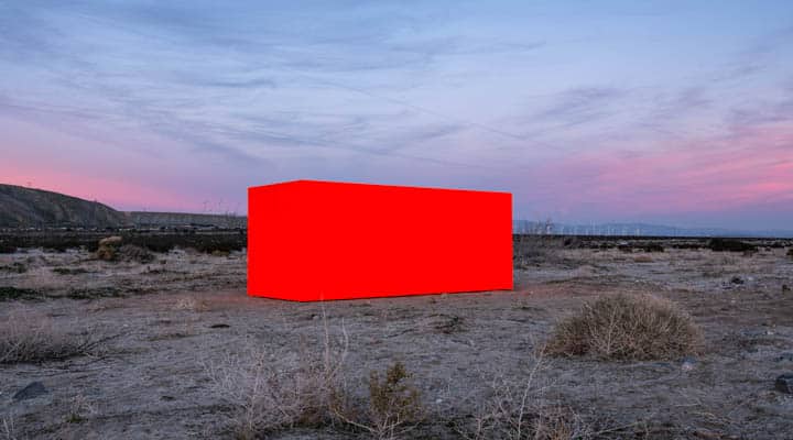 A sign on a dirt field