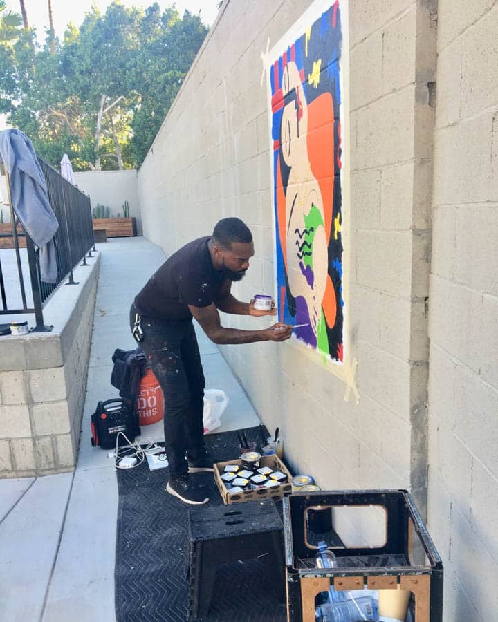 A man riding a skateboard up the side of a building