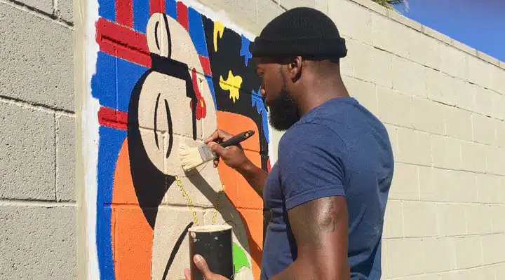 Tysen_Knight6-720x400 A man wearing a hat and sunglasses standing outside of a building