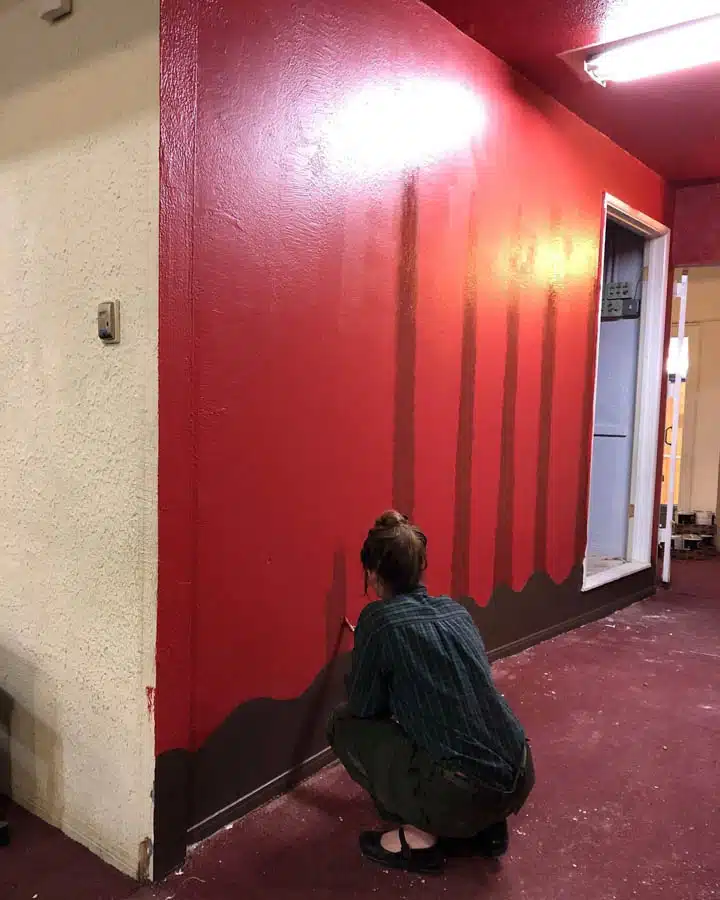 Winona2-720x900 A person standing in front of a door