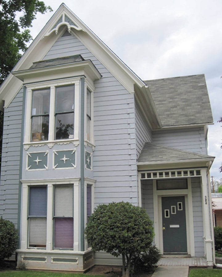 A person standing in front of a house