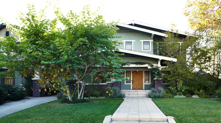 A house with a lawn in front of a building