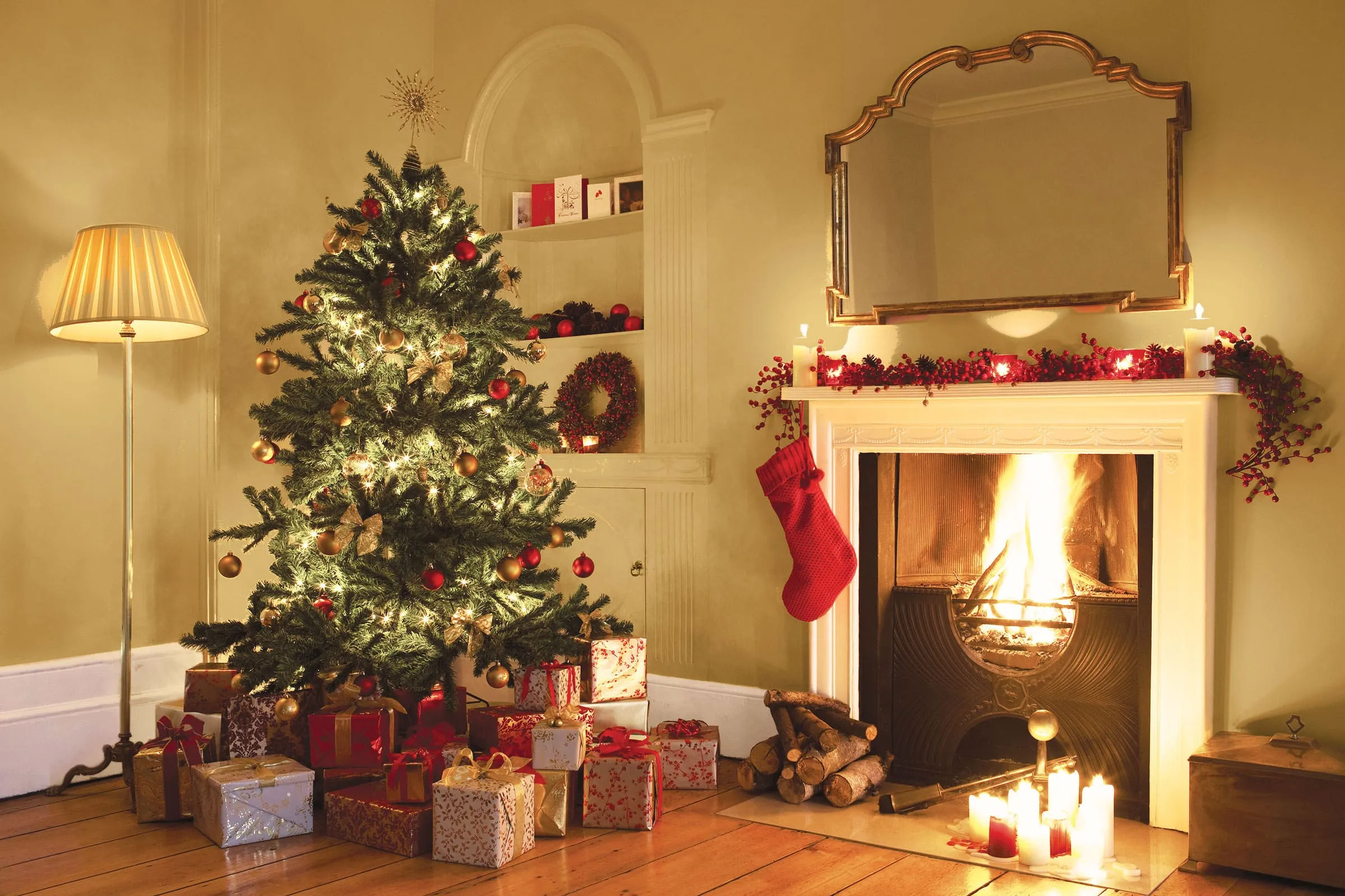 dec-iStock-96502360_super A fire place sitting in a living room with a christmas tree