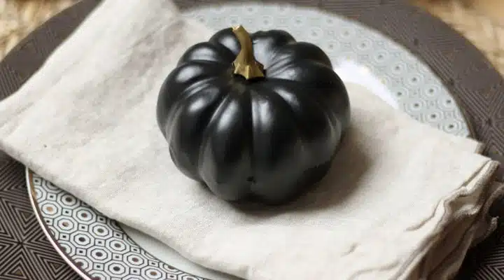 gallery-1506024064-matte-black-pumpkin A cake sitting on top of a table