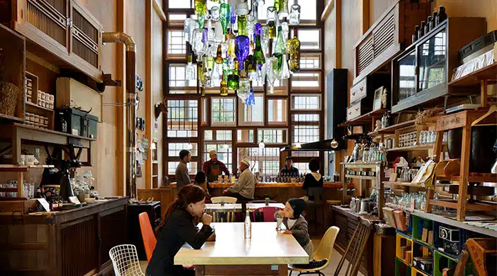 hiroshi-nakamura-NAP-architects-kamikatz-public-house-micro-brewery-japan-designboom-07-720x400 A group of people sitting at a table in a library