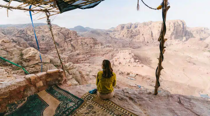 iStock-1126744242-720x400 A person sitting on a rock