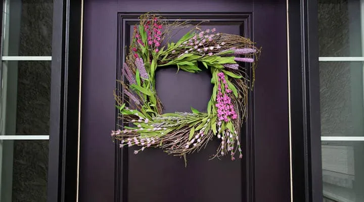 Black Front Door Spring Wreath Close Up A plant in a glass door