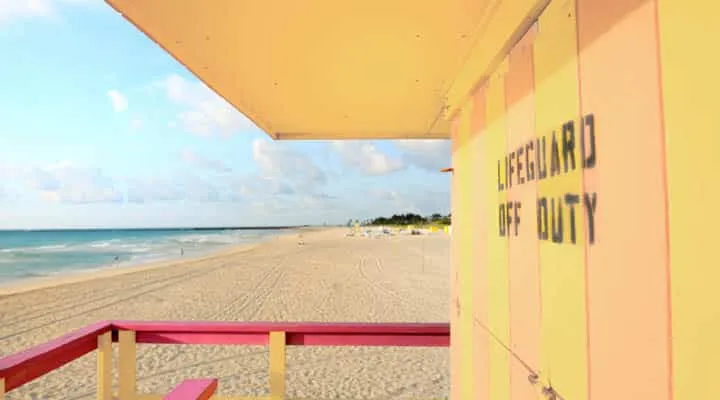 lifeguard hut on the beach at sunrise A sign on a beach