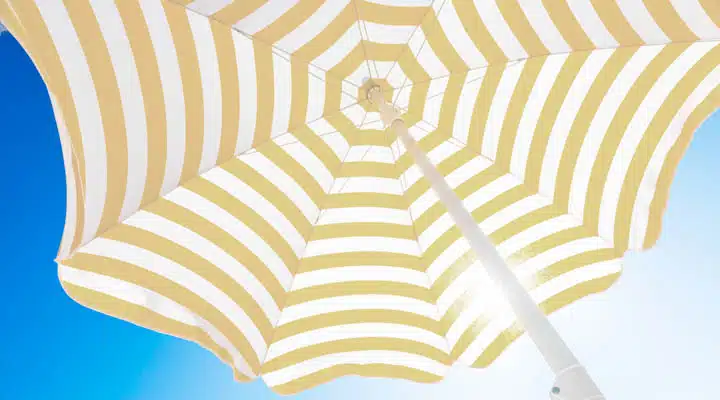 Beach umbrella against blue morning sky Background pattern