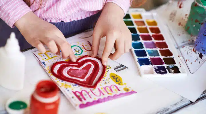 iStock-502361432 A person sitting on a cutting board with a cake