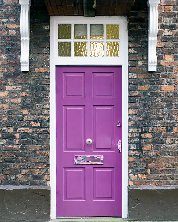 iStock-524698252-720x900 A large brick building with a purple door