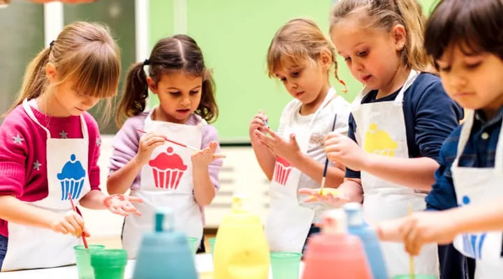 iStock_86694075_LARGE A little girl standing in front of a birthday cake