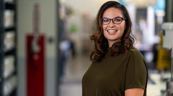 A woman standing in front of a building