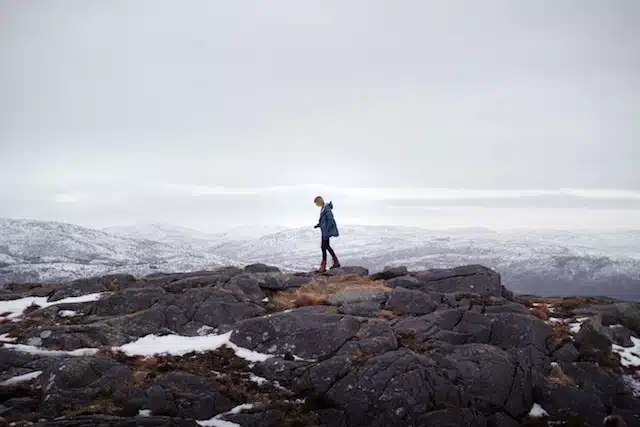sharon-christina-rorvik-188501 A man standing on a rock in the snow
