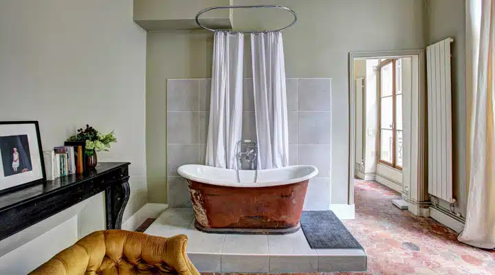 yann-maignan-376926 A living room with a couch and a tub