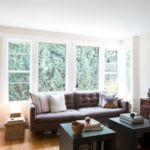 A view of a living room filled with furniture and a large window