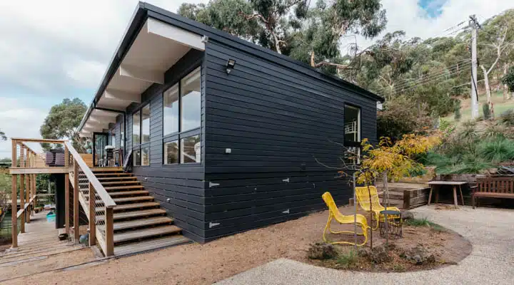 Exterior of an Australian beach house A wooden statue in front of a building