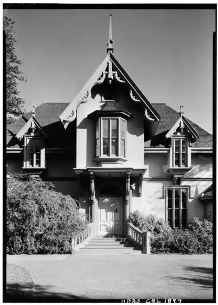 October_1960_WEST_ELEVATION__FRONT__-_J._Mora_Moss_House__Broadway_and_MacArthur_Boulevard__Oakland__Alameda_County__CA_HABS_CAL_1-OAK_2-2.tif-720px A small clock tower in front of a house