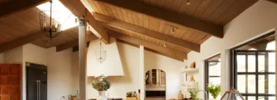 A living room filled with furniture and vase of flowers on a kitchen counter