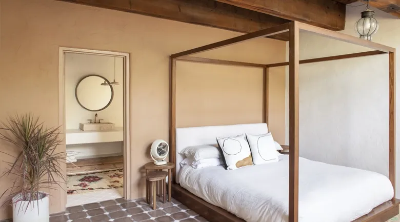 A bedroom with a bed and a mirror