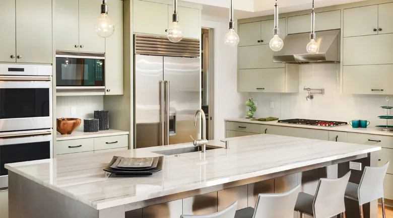 A kitchen with a table in a room