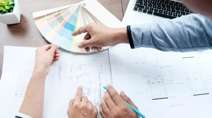 Jun21-Lead_Article A person sitting at a table using a laptop