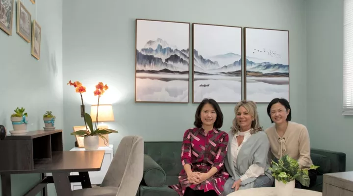 A group of people sitting at a table in front of a window