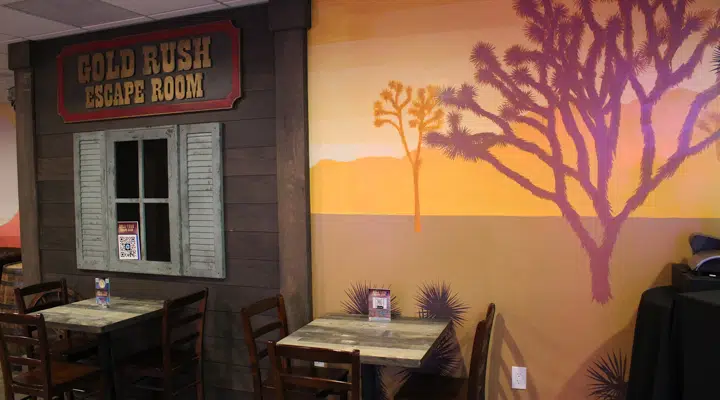 A room with a couch a table and chairs