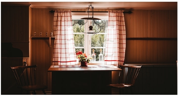 A kitchen with wooden cabinets and a window
