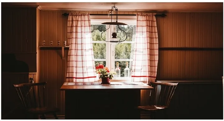 A kitchen with wooden cabinets and a window