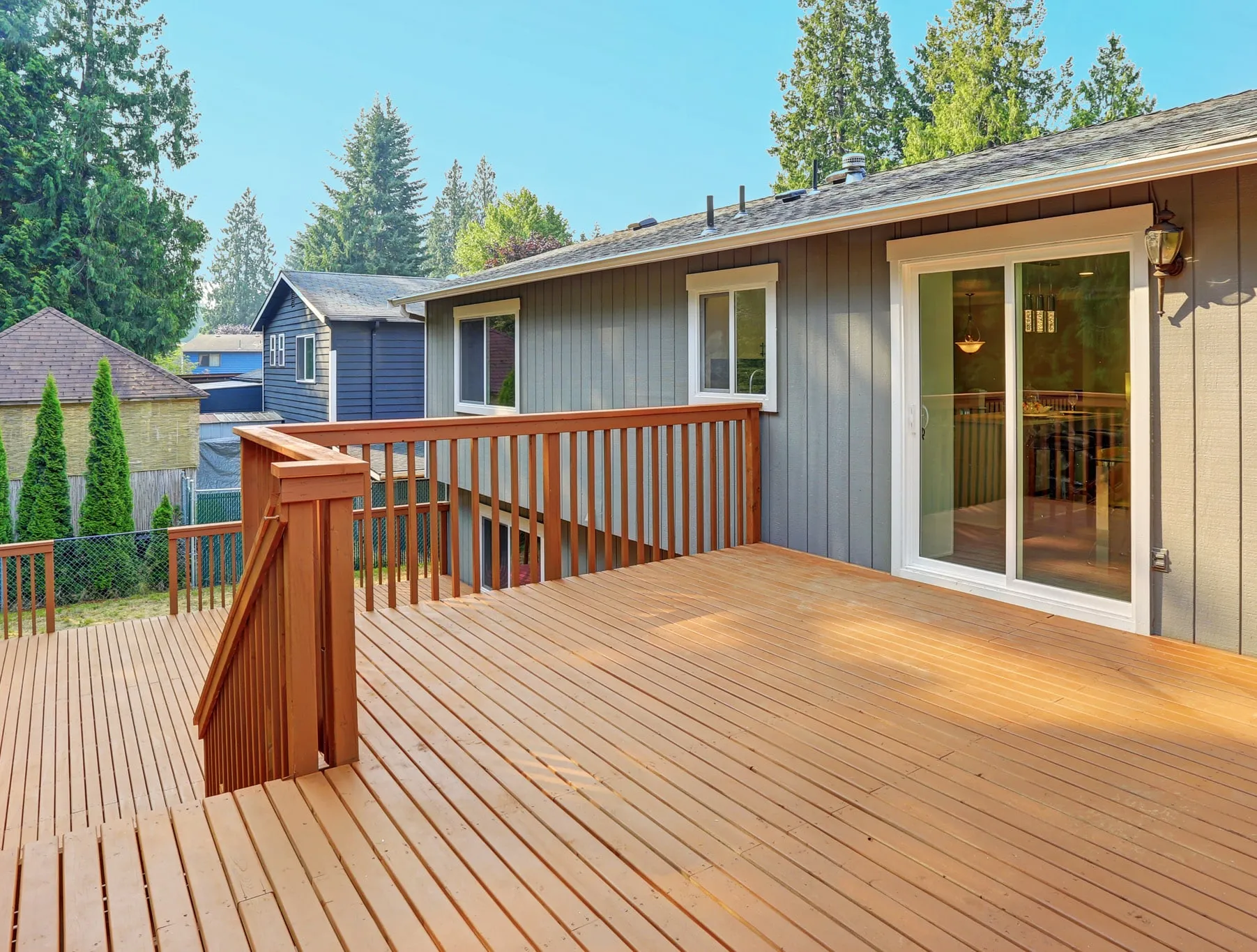 A wooden deck in front of a house