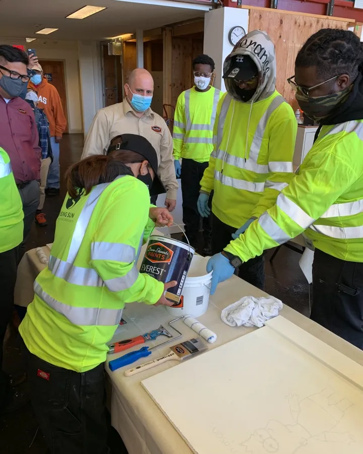 Dunn-Edwards team pouring paint