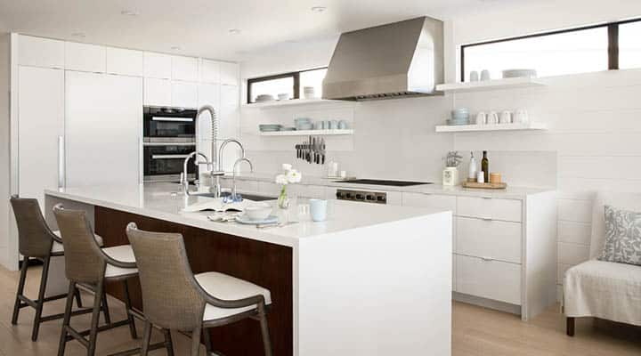 A kitchen with a table in a room