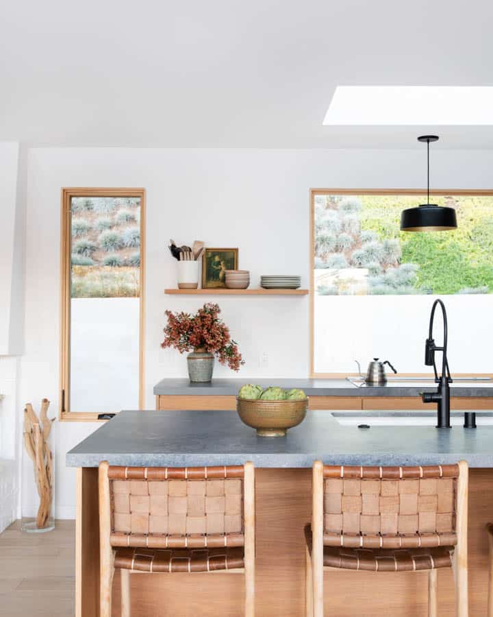 A kitchen with wooden cabinets and a table in a room