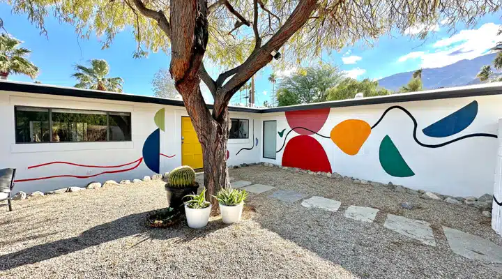 A sign in front of a tree