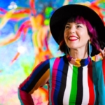 A person holding a colorful kite