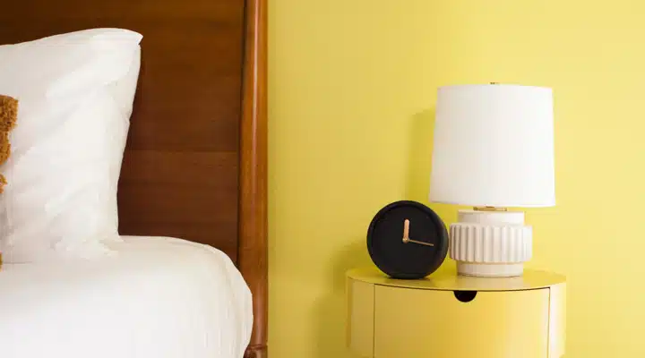 A bedroom with a bed and desk in a small room